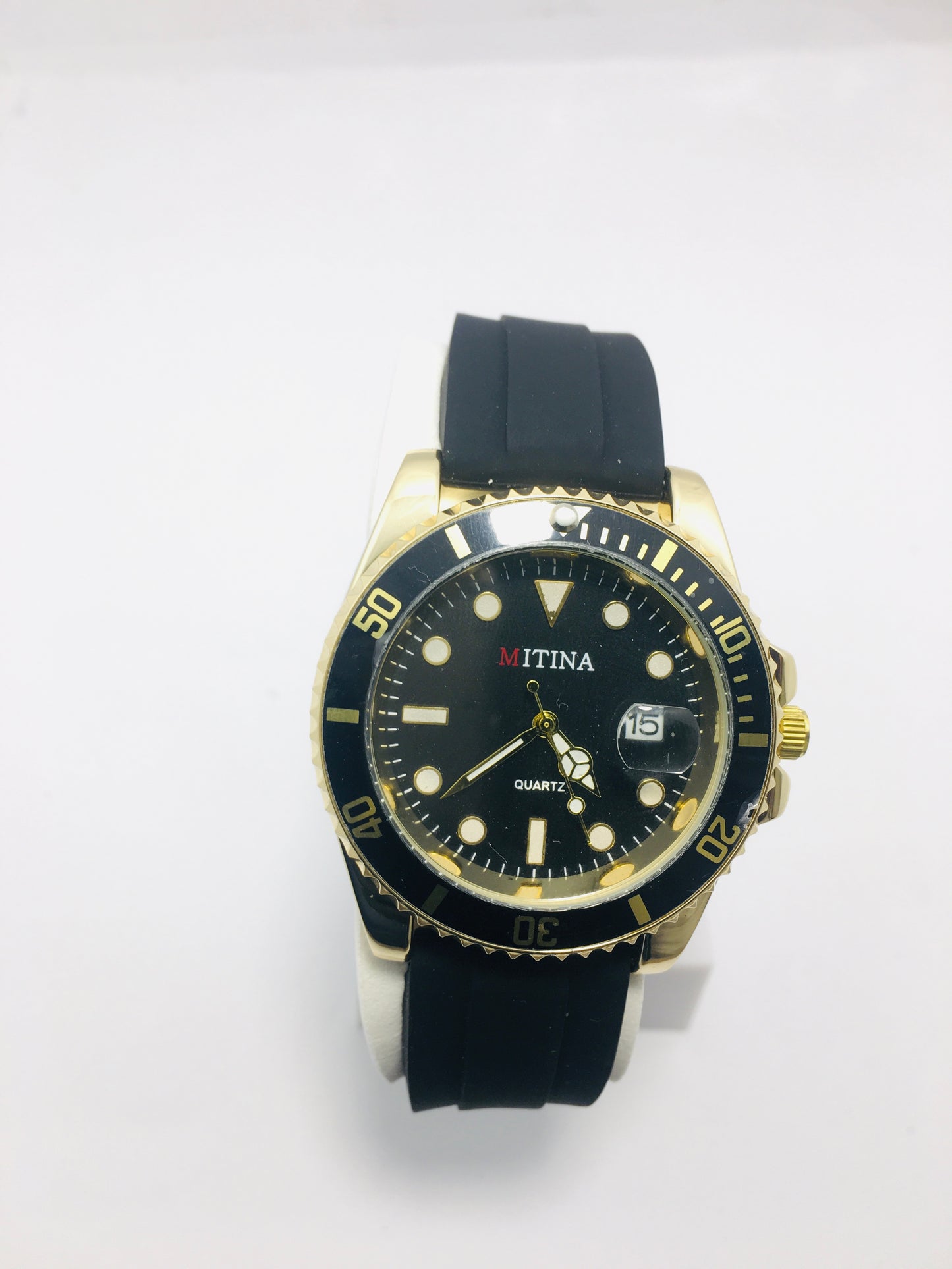 Mitina Movement diver-style watch with a black dial, gold-colored accents, a rotating bezel, and a date window. Rubber strap black